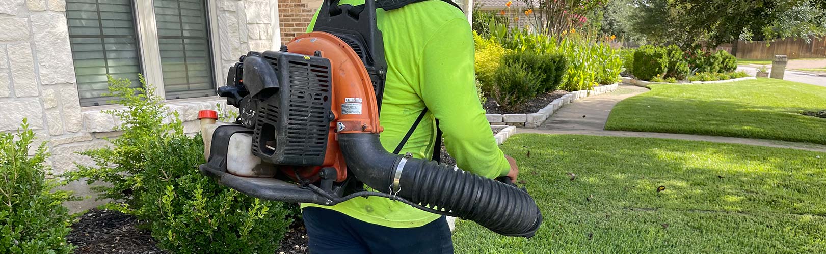 blowing away grass clippings after mowing lawn