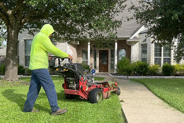 man mowing lawn in College Station